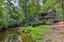 Nestled on the banks of the Cullasaja river, this magnificent for sale in Highlands North Carolina Macon County County on GolfHomes.com