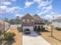 GOLF CART TO THE BEACH! This beautiful 4 bedroom, 2.5  bath home for sale in Surfside Beach South Carolina Horry County County on GolfHomes.com