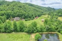 Nestled in the scenic landscape of western NC, this horse farm for sale in Hayesville North Carolina Clay County County on GolfHomes.com