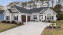 Discover coastal elegance nestled in the tranquil Windsong for sale in Little River South Carolina Horry County County on GolfHomes.com