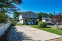 This well-proportioned home offers a formal dining room for sale in Brentwood New York Suffolk County County on GolfHomes.com