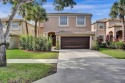 Located on a quiet, tree-lined street and surrounded by lush for sale in Royal Palm Beach Florida Palm Beach County County on GolfHomes.com