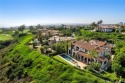 Nestled serenely on the front row, this extraordinary estate for sale in Newport Coast California Orange County County on GolfHomes.com