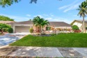 Welcome to a truly unique property nestled in the Woodlake for sale in Deerfield Beach Florida Broward County County on GolfHomes.com