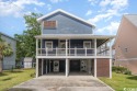 This stunning raised Beach House in Cherry Grove is located only for sale in North Myrtle Beach South Carolina Horry County County on GolfHomes.com