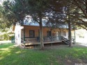 LOG SIDED HOME ON LEVEL LOT!  Beautiful knotty pine walls and for sale in Cherokee Village Arkansas Fulton County County on GolfHomes.com