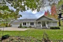 Discover serenity in this spacious Canadian Lakes home featuring for sale in Canadian Lakes Michigan Mecosta County County on GolfHomes.com