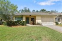 Discover the epitome of maintenance-free living in this vibrant for sale in New Port Richey Florida Pasco County County on GolfHomes.com