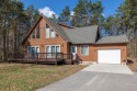 Nestled within a serene, wooded backdrop at the end of a for sale in Canadian Lakes Michigan Mecosta County County on GolfHomes.com