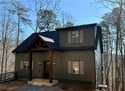 Welcome to this custom-built modern craftsman cabin nestled for sale in Ellijay Georgia Gilmer County County on GolfHomes.com