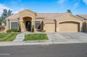 A custom oversized iron front door, welcomes you into this for sale in Chandler Arizona Maricopa County County on GolfHomes.com