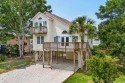 Welcome to 154 Cedar Point Avenue, a classic raised beach home for sale in Murrells Inlet South Carolina Georgetown County County on GolfHomes.com