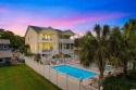 Welcome to 213B South Myrtle Drive, an exquisite raised beach for sale in Surfside Beach South Carolina Horry County County on GolfHomes.com