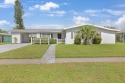 Welcome to this inviting 1963 two-bedroom, two-bathroom home for sale in Port Charlotte Florida Charlotte County County on GolfHomes.com