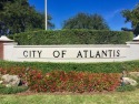Very desirable bottom floor condo with views of the water, golf for sale in Atlantis Florida Palm Beach County County on GolfHomes.com