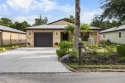 Beautiful CBC home backing to canal.  Magnificent landscaping for sale in Port Saint Lucie Florida Saint Lucie County County on GolfHomes.com