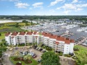 Welcome to Coquina Harbour! Step out and enjoy gorgeous Marina for sale in Little River South Carolina Horry County County on GolfHomes.com