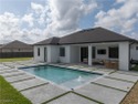 Discover refined Florida living in this exquisite 2024-built for sale in Cape Coral Florida Lee County County on GolfHomes.com