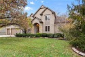 This stunning 1.5-story home is perfectly set on a scenic golf for sale in Lenexa Kansas Johnson County County on GolfHomes.com