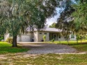 Country living meets modern convenience in this serene wooded for sale in New Smyrna Beach Florida Volusia County County on GolfHomes.com