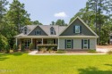 Welcome to this beautiful custom-built 4-bedroom, 3.5-bath home for sale in Whispering Pines North Carolina Moore County County on GolfHomes.com