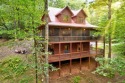 Tucked away on 2.32 wooded acres, this fully furnished 4BR/3.5BA for sale in Ellijay Georgia Gilmer County County on GolfHomes.com