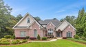 This exquisite four-sided blush brick estate is the epitome of for sale in Flowery Branch Georgia Hall County County on GolfHomes.com