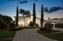 Experience breathtaking long lake views from this grand estate for sale in Boca Raton Florida Palm Beach County County on GolfHomes.com