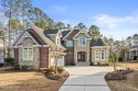 This beautiful custom brick and stone home has numerous upgrades for sale in Ocean Isle Beach North Carolina Brunswick County County on GolfHomes.com