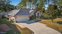 BRAND NEW ROOF! SPARKLING POOL! TWO PRIMARY BEDROOM SUITES! for sale in Palm Coast Florida Flagler County County on GolfHomes.com