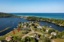 100 feet of EXCEPTIONAL LAKE FRONTAGE improved and protected for sale in Arcadia Michigan Manistee County County on GolfHomes.com
