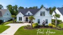 Step into luxury living in Cape Fear National, the most coveted for sale in Leland North Carolina Brunswick County County on GolfHomes.com