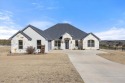 Custom built home in prestigious Rolling Creek Ranch. This for sale in Granbury Texas Hood County County on GolfHomes.com