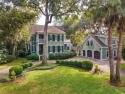 The pond view is breathtaking! This Low Country 5 bedroom, 5 for sale in Georgetown South Carolina Georgetown County County on GolfHomes.com