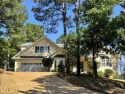 Situated overlooking one of Isabella Golf Course's scenic par 3s for sale in Hot Springs Village Arkansas Saline County County on GolfHomes.com