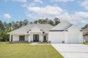 Experience luxury lake view living at its finest with this for sale in Milton Florida Santa Rosa County County on GolfHomes.com