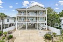 Discover coastal elegance in this stunning 6 bed, 5.5 bath beach for sale in North Myrtle Beach South Carolina Horry County County on GolfHomes.com