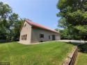 Tucked away in the woods on a spacious 1.8-acre lot, this modern for sale in Annandale Minnesota Wright County County on GolfHomes.com