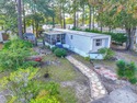 Welcome to Beach Living at Its Best! Enjoy coastal life in this for sale in Garden City Beach South Carolina Horry County County on GolfHomes.com