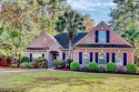 Welcome home to this custom, all-brick home on a large corner for sale in Murrells Inlet South Carolina Horry County County on GolfHomes.com