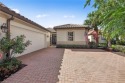 Spacious courtyard home with salt water pool and spa now for sale in Estero Florida Lee County County on GolfHomes.com