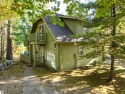 This charming cottage-style property at Garland Lodge and Golf for sale in Lewiston Michigan Oscoda County County on GolfHomes.com