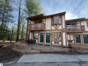 Welcome to an exceptional retreat at Schuss Mountain! This rare for sale in Mancelona Michigan Antrim County County on GolfHomes.com