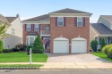 This elegant brick-front home offers the perfect blend of style for sale in Manalapan New Jersey Monmouth County County on GolfHomes.com