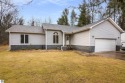 Nestled on a spacious, wooded lot, this welcoming home combines for sale in Kalkaska Michigan Kalkaska County County on GolfHomes.com