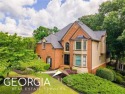 Welcome to your dream home! This exquisite four-bedroom property for sale in Woodstock Georgia Cherokee County County on GolfHomes.com