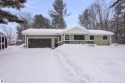 Nestled in a quiet and charming neighborhood just minutes from for sale in Kalkaska Michigan Kalkaska County County on GolfHomes.com