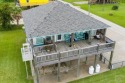 This three-bedroom two bath home is in a quiet area with green for sale in Port Bolivar Texas Galveston County County on GolfHomes.com