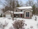 Discover the perfect blend of privacy and convenience in this for sale in Charlevoix Michigan Charlevoix County County on GolfHomes.com