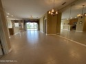 A beautiful former model home, this gated, paired-villa (duplex) for sale in Fleming Island Florida Clay County County on GolfHomes.com